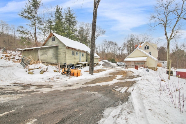 view of snowy exterior featuring a garage