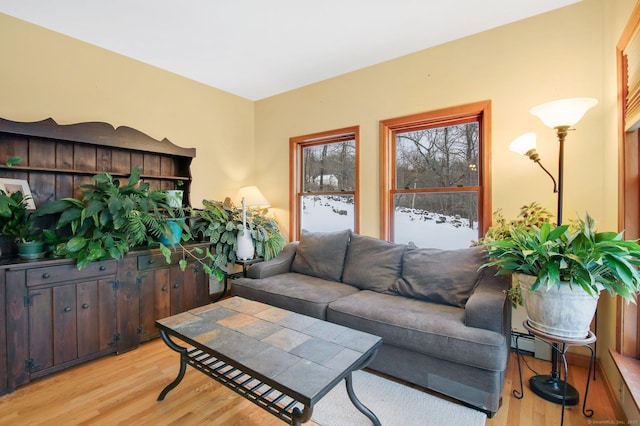 living room featuring baseboard heating and light wood-type flooring