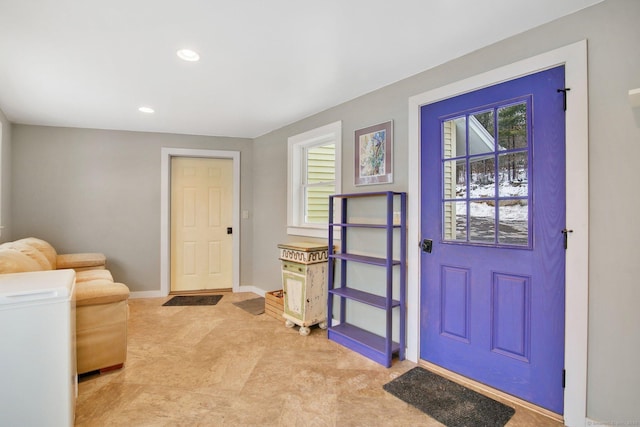 foyer with plenty of natural light, recessed lighting, and baseboards