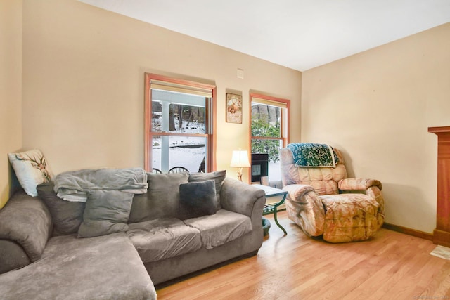 living room featuring baseboards and light wood-type flooring