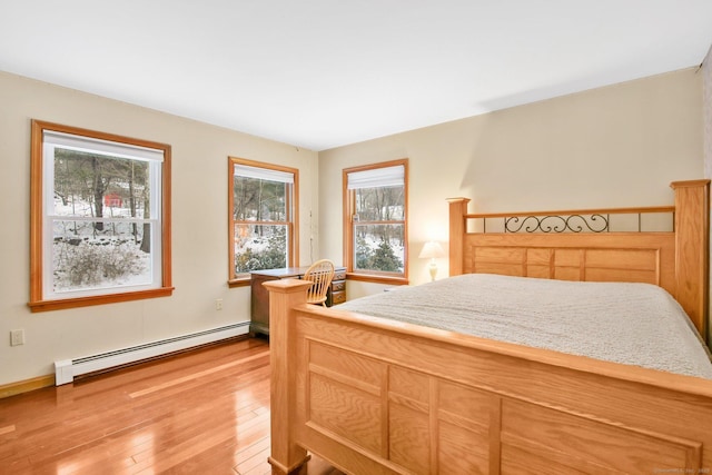 bedroom featuring a baseboard radiator and light wood-style floors