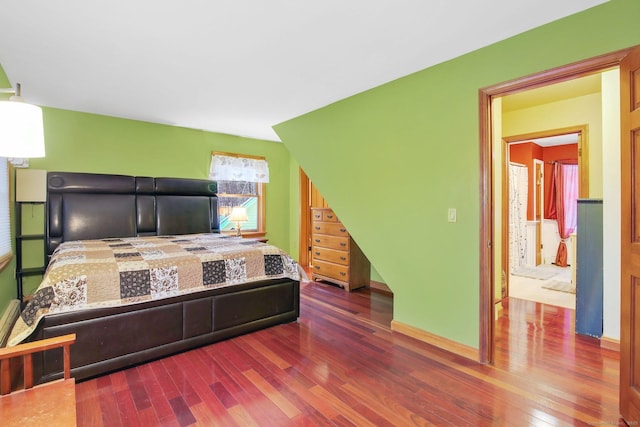 bedroom with baseboards and wood finished floors