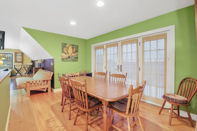 dining room with a wealth of natural light, light wood-type flooring, and baseboards