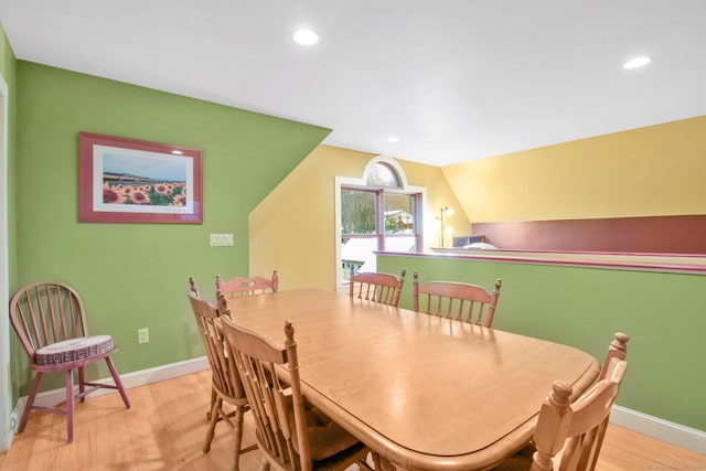 dining space featuring recessed lighting, baseboards, lofted ceiling, and wood finished floors