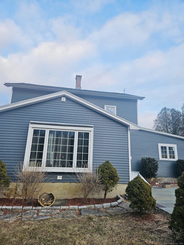 view of side of property with a chimney