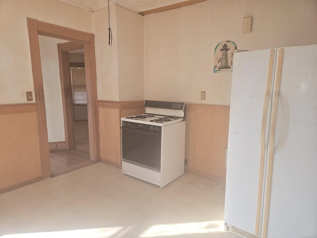 kitchen featuring white appliances and wainscoting