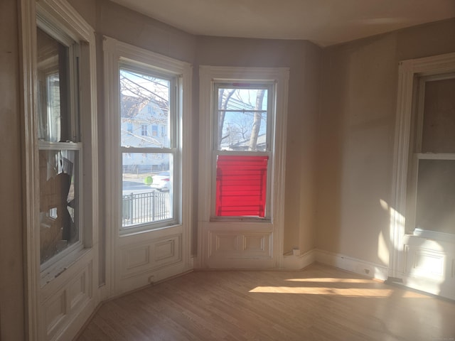 interior space featuring baseboards and wood finished floors