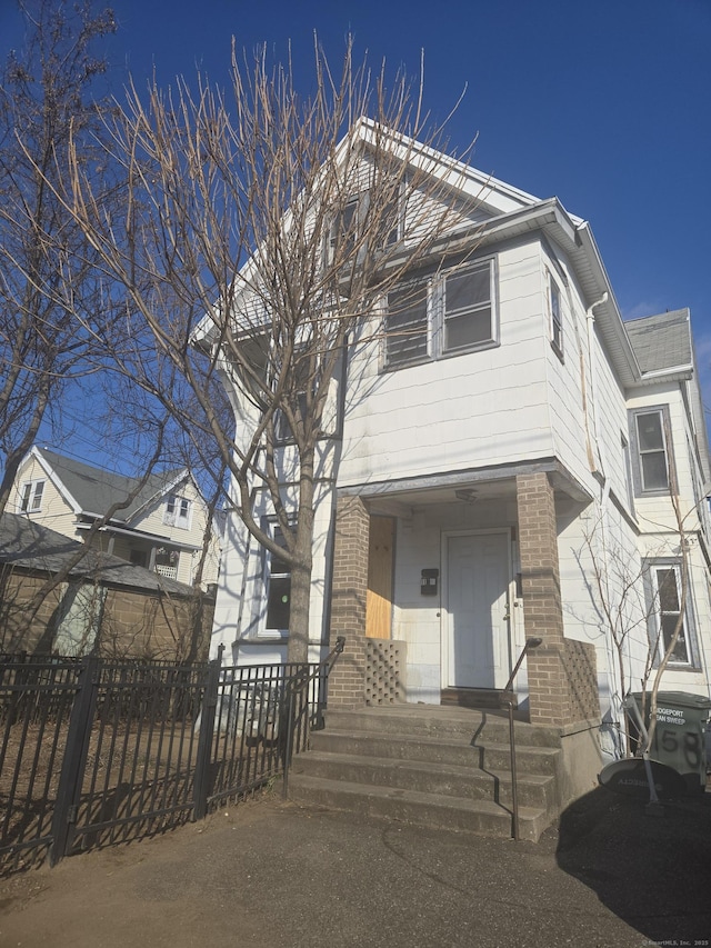 view of front of house with brick siding and a fenced front yard