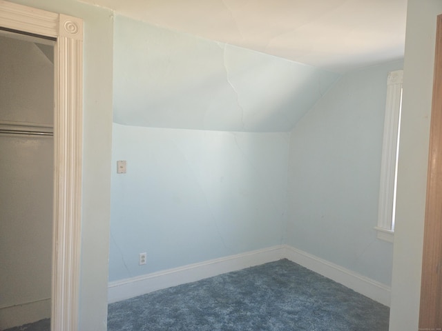 additional living space with lofted ceiling, carpet flooring, and baseboards