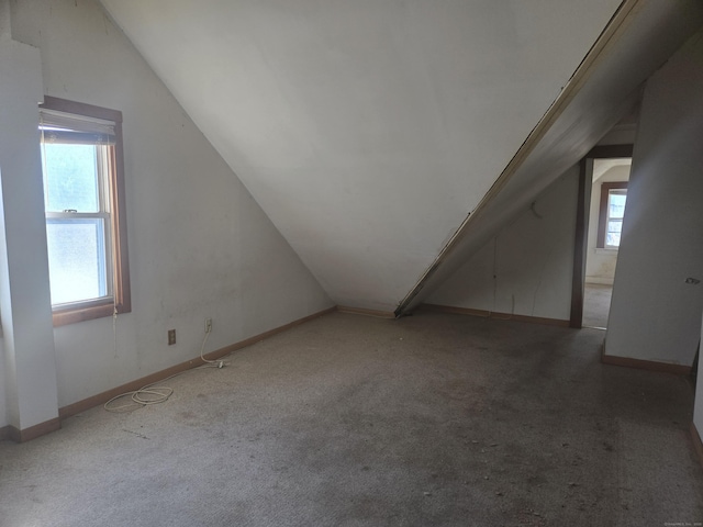 bonus room featuring carpet flooring, baseboards, and lofted ceiling