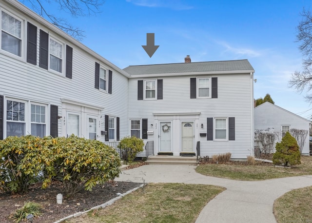 colonial-style house with a chimney