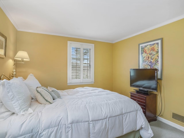 bedroom with visible vents, baseboards, crown molding, and carpet