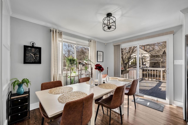 dining room with dark wood-style floors, baseboards, and ornamental molding