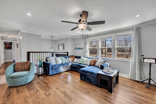 living area with recessed lighting, baseboards, wood finished floors, and ornamental molding