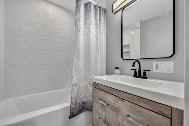 bathroom featuring shower / bath combo and vanity