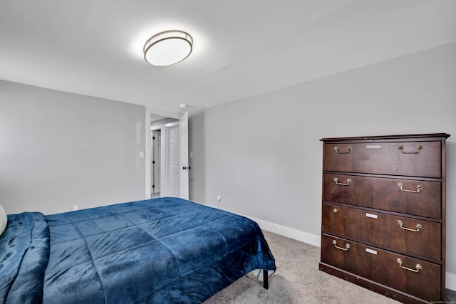 bedroom with light colored carpet and baseboards