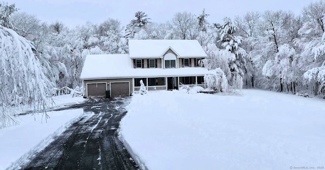 view of front of home featuring a garage and a sunroom