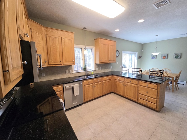 kitchen featuring visible vents, plenty of natural light, dishwasher, and a peninsula