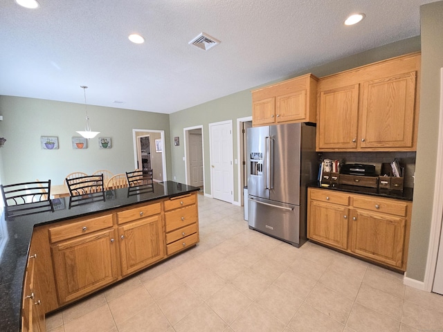 kitchen with dark countertops, visible vents, recessed lighting, hanging light fixtures, and high end fridge