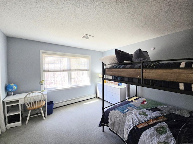 bedroom with a baseboard heating unit, carpet, visible vents, and a textured ceiling