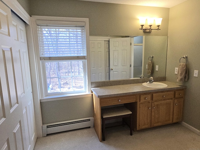 bathroom with vanity, baseboards, and a baseboard radiator