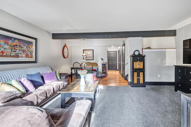 carpeted living area featuring stairs