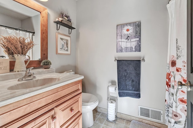 bathroom with tile patterned floors, visible vents, toilet, and vanity