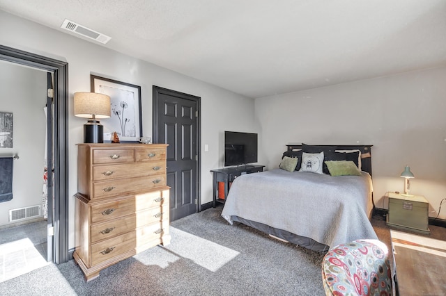 bedroom with visible vents and carpet