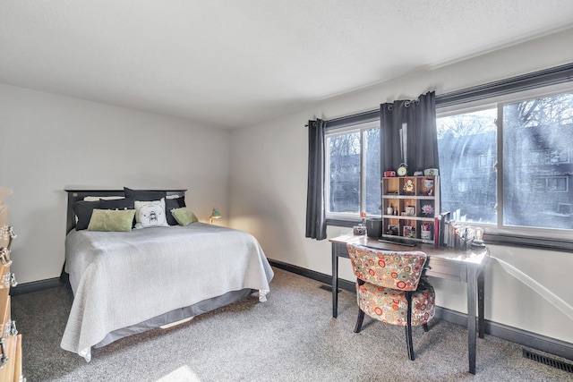 carpeted bedroom featuring visible vents and baseboards