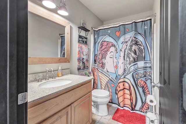 bathroom featuring toilet, vanity, and a shower with curtain