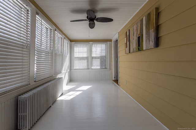 sunroom / solarium with radiator and ceiling fan