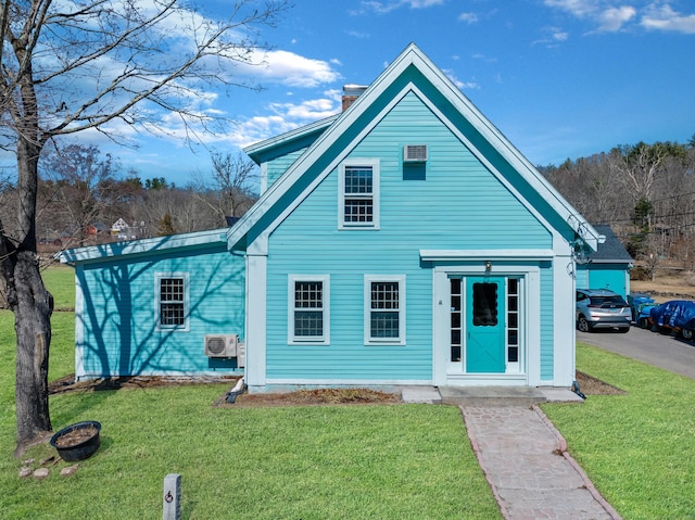 view of front of house featuring a chimney and a front yard