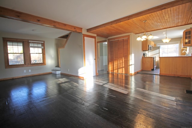 unfurnished living room featuring beamed ceiling, baseboards, dark wood-type flooring, and stairs