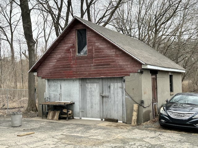 view of outbuilding with an outdoor structure and fence