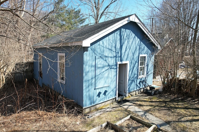 view of outbuilding featuring an outbuilding and fence