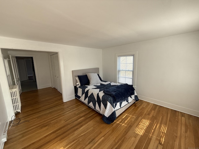 bedroom featuring baseboards and wood finished floors