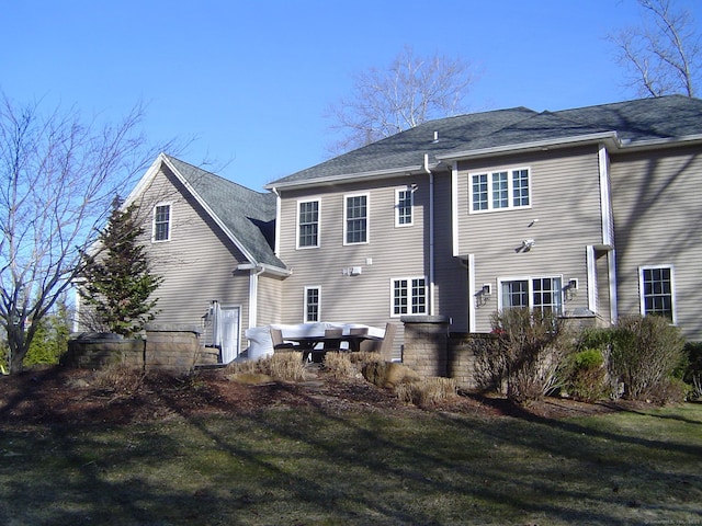 rear view of house with a yard