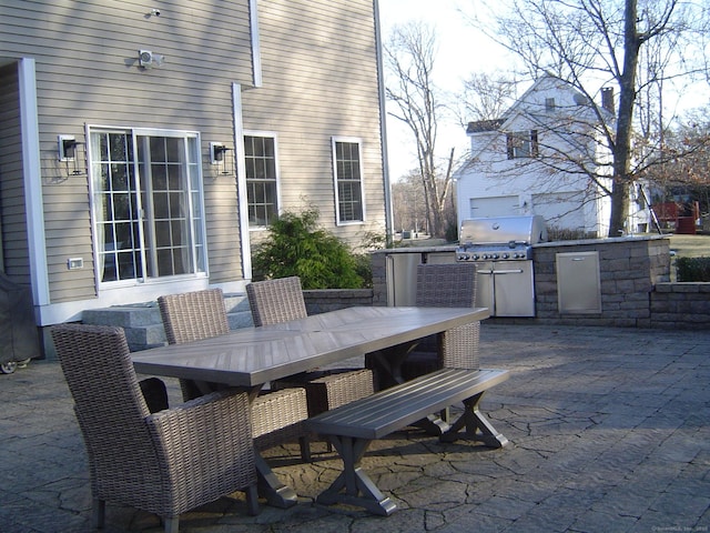 view of patio featuring grilling area, exterior kitchen, and outdoor dining area