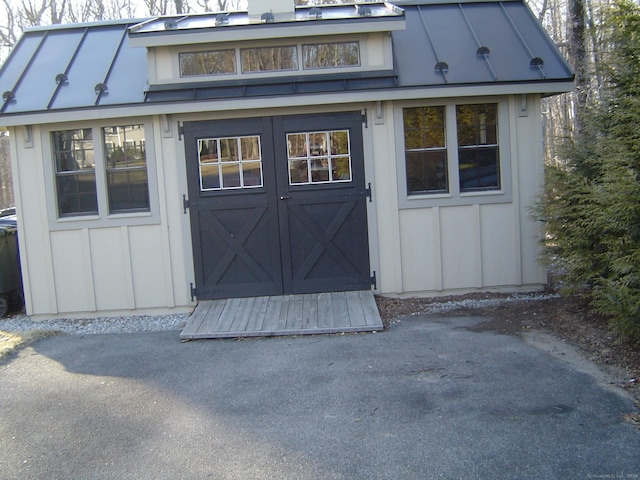 view of shed with aphalt driveway