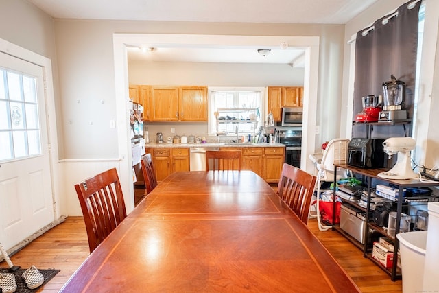 dining space with wood finished floors