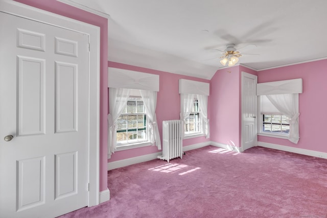 bonus room with lofted ceiling, a ceiling fan, radiator heating unit, carpet floors, and baseboards