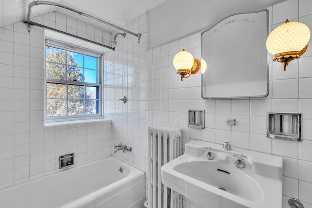 full bath featuring radiator heating unit, a tub, a sink, walk in shower, and tile walls