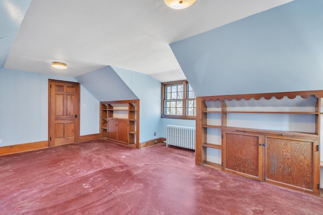 bonus room with baseboards, lofted ceiling, and radiator