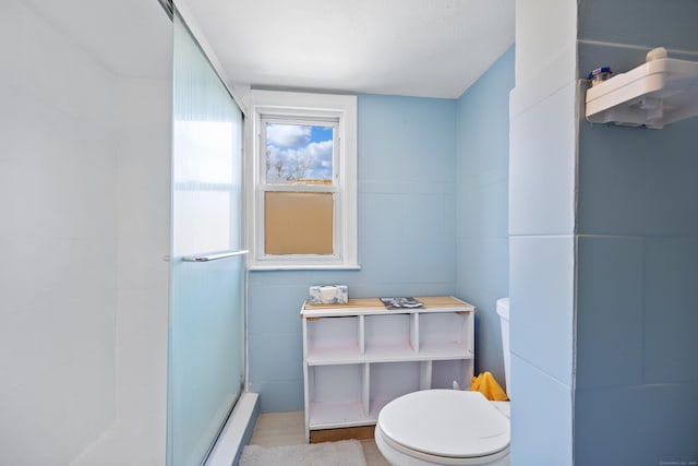 full bathroom with a shower stall and toilet