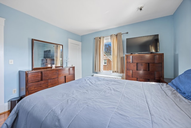 bedroom featuring radiator and baseboards