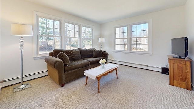 living room with a wealth of natural light, baseboard heating, and carpet floors