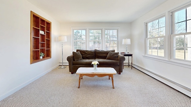 living area with a baseboard heating unit, plenty of natural light, baseboards, and baseboard heating