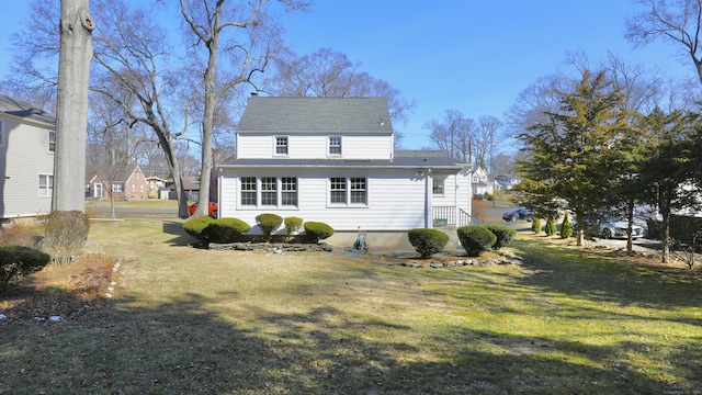 back of property featuring a yard