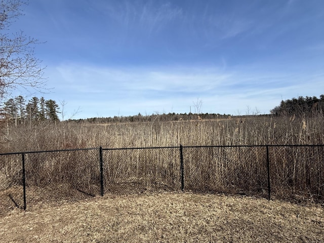 view of yard with a rural view and fence