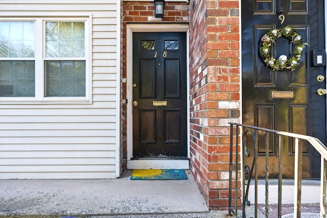 entrance to property featuring brick siding